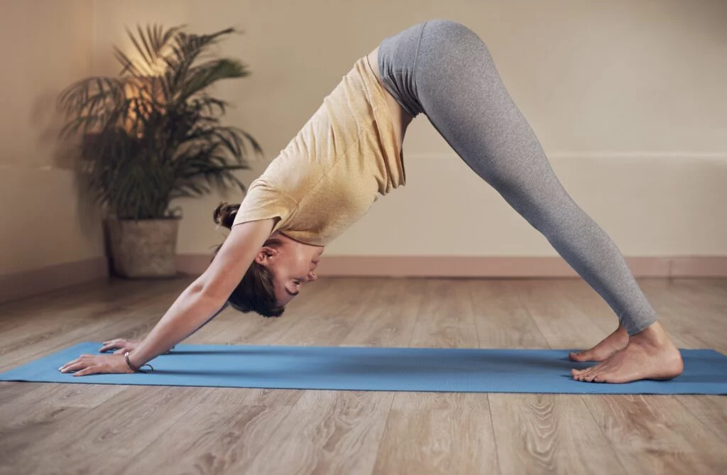 Woman,,Yoga,And,Downward,Dog,In,Home,For,Health,,Wellness - welltica.dk - Vejen til et bedre liv