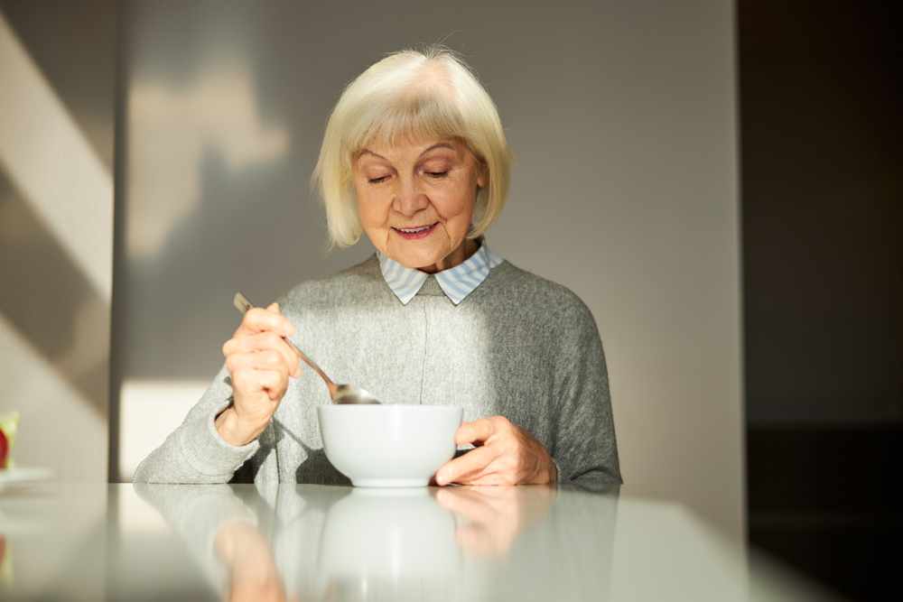 PortraitOfAPleasantSmilingPleasedFemalePensionerEatingHer - welltica.dk - Vejen til et bedre liv