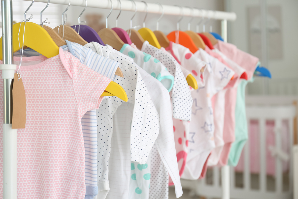 BabyClothesHangingOnRackInStoreShoppingConcept - welltica.dk - Vejen til et bedre liv