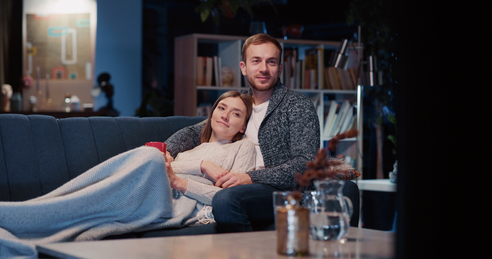 CheerfulAffectionateGirlfriendWithBoyfriendUsingLaptopTogetherOnSofa - welltica.dk - Vejen til et bedre liv