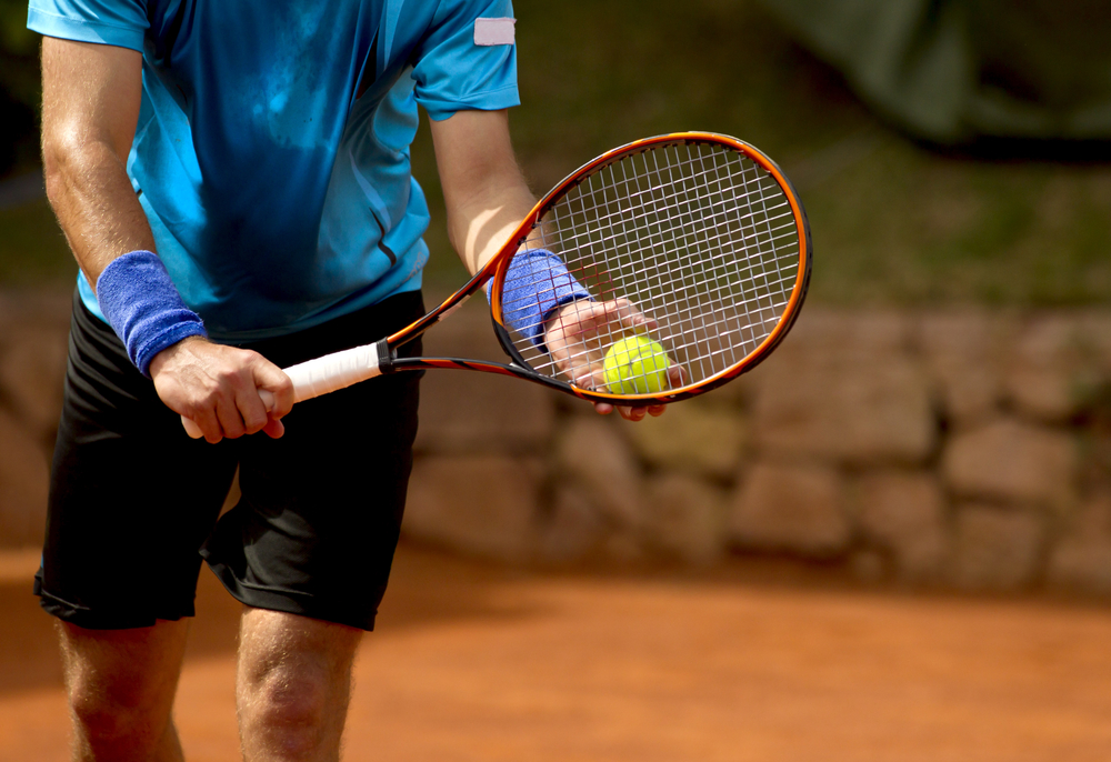 ATennisPlayerPreparesToServeATennisBallDuring - welltica.dk - Vejen til et bedre liv